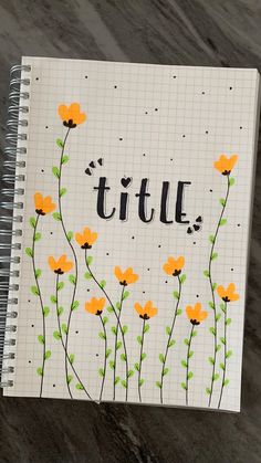 a notebook with the word title written in black ink and yellow flowers on white paper