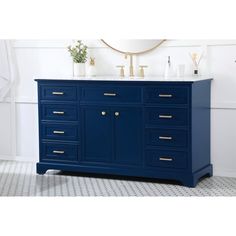 a bathroom vanity with two sinks and gold faucets on the top, against a white wall