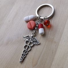 a keychain with medical symbols on it sitting on top of a wooden table