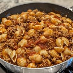 pasta with meat and sauce in a pan on the stove