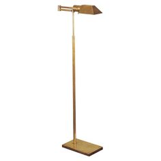 a gold floor lamp with a white background