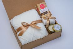 the baby gift box is packed with blankets and candles