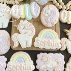 cookies decorated with unicorns and rainbows on a table