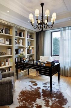 a living room filled with furniture and a cowhide rug