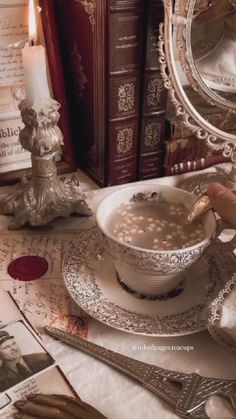 a table topped with plates and silverware next to a book shelf filled with books