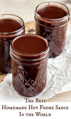 three jars filled with chocolate sitting on top of a piece of wax paper next to each other