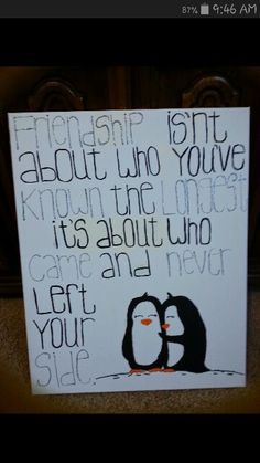 a sign that has some writing on it and two penguins in front of the words