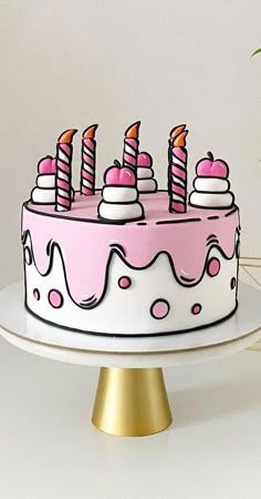 a birthday cake with pink frosting and lit candles on top, sitting on a gold pedestal