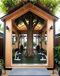 the inside of a home gym with trees and benches