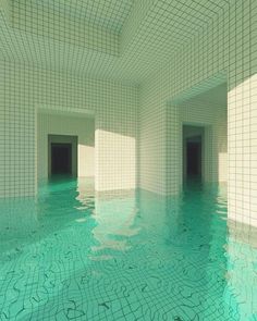 an empty swimming pool with blue water and white tiles on the walls is pictured in this image