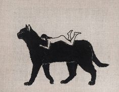 a black cat with a woman laying on top of it's back in front of a white background