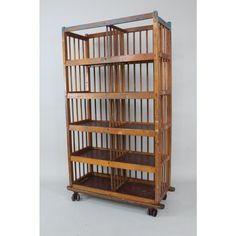 a wooden shelf with four shelves on wheels