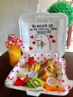 a white box filled with lots of food on top of a table