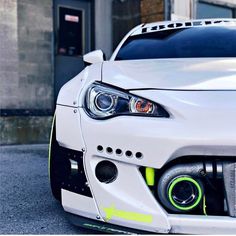 the front end of a white sports car