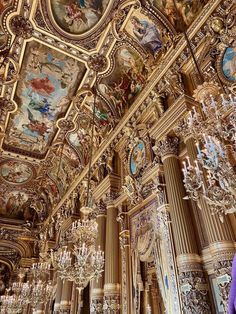 an ornately decorated room with chandeliers and paintings