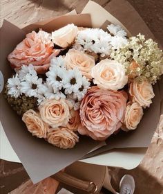 a bouquet of flowers sitting on top of a table next to a pair of scissors