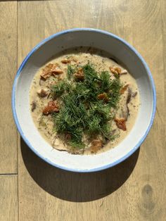 a white bowl filled with food on top of a wooden table