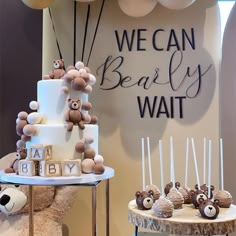 there is a teddy bear cake and other desserts on the table with balloons in the background