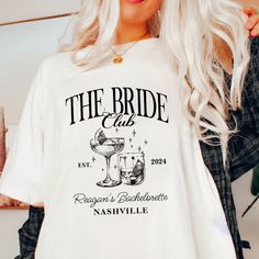 a woman wearing a t - shirt that says the bride club and has a martini in it