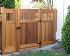 a wooden gate in front of a house