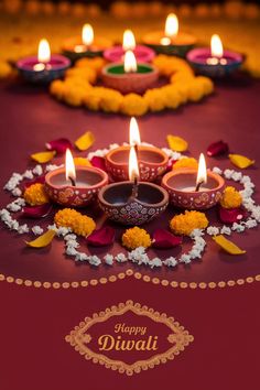 diwali with lit candles and flowers on the ground