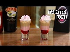 two drinks sitting on top of a wooden table