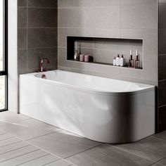 a white bath tub sitting inside of a bathroom