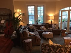 a living room filled with furniture and lots of windows