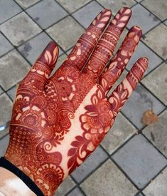 a person's hand with henna on it