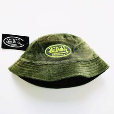 DEADSTOCK NEW WITH TAGS KHAKI GREEN FLEECE VON DUTCH BUCKET HAT Vintage Khaki Green Fleece Von Dutch Bucket Hat / Von Dutch Hat / Von Dutch Cord Bucket Hat / Fleece Bucket Hat Soft Fleece Material Throughout With Embroidered Neon Green Von Dutch Logo On Front One Size Fits All, Adults/Unisex 90s Y2K Festival UK AND WORLDWIDE SHIPPING. Von Dutch Red Camo Hat, Green Bucket Hat For Sports, Green Sports Bucket Hat, Casual Green Bucket Hat For Outdoor Activities, Green Military Bucket Hat With Short Brim, Green Military Style Bucket Hat, Green Military Bucket Hat, Green Bucket Hat For Streetwear, Green Short Brim Bucket Hat For Streetwear