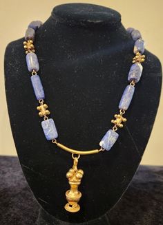 Pre Colombian Necklace, one of a kind  21 inches long, blue stone and gold plated , with a historic indigenes 2 inches pendant Bohemian Gold Lapis Lazuli Necklace, Artisan Brass Jewelry With Gemstone Beads, Traditional Gold Jewelry With Lapis Lazuli, Traditional Gold Lapis Lazuli Jewelry, Unique Gold Single Strand Jewelry, Unique Single Strand Gold Jewelry, Artisan Gold Jewelry With Lapis Lazuli, Artisan Gold Lapis Lazuli Jewelry, Artisan Yellow Gold Necklaces With Natural Stones