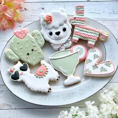 decorated cookies are arranged on a white plate