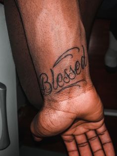 a man's foot with the word blessed written on it, in black ink