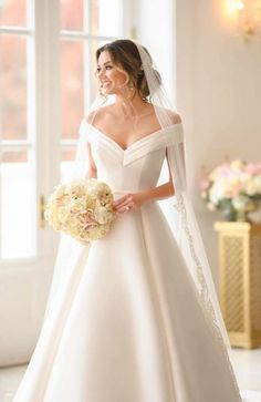 a woman in a wedding dress holding a bouquet