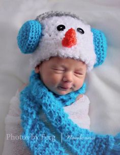 a baby wearing a snowman hat and scarf