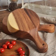 two wooden bowls with cherry tomatoes on them