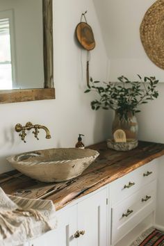 a bowl sink sitting on top of a wooden counter