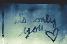 the words i love you are written in black ink on a frosted glass window