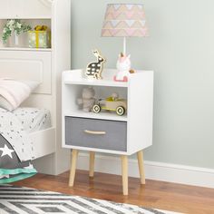 a child's bedroom with a white and grey nightstand