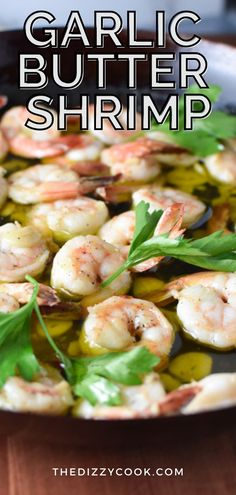 garlic butter shrimp in a skillet with olives and parsley on the side