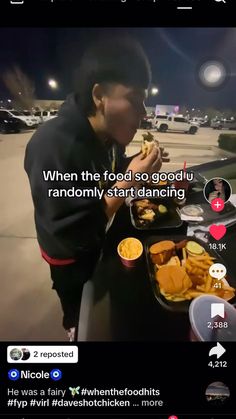 a man eating food on top of a table next to an open cell phone with the caption'when the food so good you randomly start dancing '