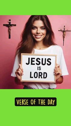 a woman holding up a sign that says jesus is lord verse of the day on it