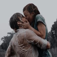 two people in the rain hugging each other