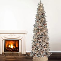 a decorated christmas tree in front of a fireplace