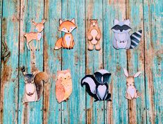 paper animals are arranged on a wooden surface