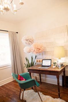 a desk with a laptop on it in a room