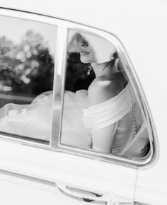 a woman sitting in the back seat of a car