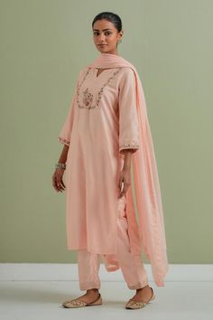 Peach kurta with floral embroidery and side slits. Paired with pant and cotton dupatta.
Components: 3
Pattern: Embroidered
Type Of Work: Floral
Neckline: Notched
Sleeve Type: Three quarter
Fabric: Chanderi silk, kota cotton
Color: Peach
Other Details: 
Side slits
Floral embroidery
Occasion: Puja - Aza Fashions Peach Palazzo Set With Resham Embroidery, Peach Sharara With Resham Embroidery, Designer Wear Straight Kurta In Peach, Peach Chikankari Embroidery Set, Festive Peach Cotton Sets, Peach Straight Kurta With Zari Work, Peach Chanderi Salwar Kameez, Peach Straight Kurta Set For Festive Occasion, Festive Peach Straight Kurta Set