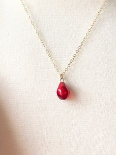 A beautiful delicate pomegranate seed necklace. This lovely pomegranate seed is so realistic, yet it is handblown glass. It has a beautiful deep red/burgundy hue. It is translucent in the sunlight with faceted surfaces. It truly looks like a real pomegranate seed. Each pomegranate seed bead is measures approx. 12 mm in length The gold filled chain is delicate measuring approx. 16 to 18 inches with an extender so you can wear it short or a bit longer. The pomegranate plant is evergreen throughout Pomegranate Plant, Pomegranate Dressing, October Jewelry, Fairy Headpiece, Pomegranate Necklace, Small Girly Tattoos, Seed Necklace, Bainbridge Island, Cotton Drawstring Bags