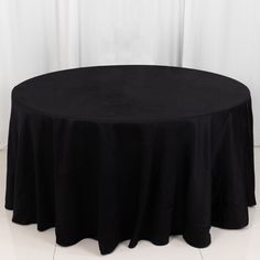 a round table with black cloth on it